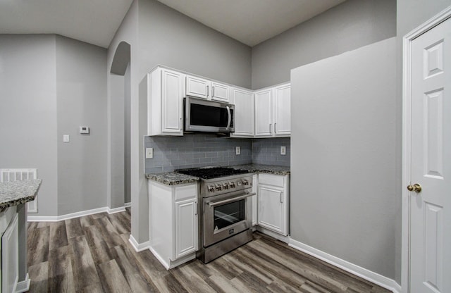 22718 Red Pine Dr, Tomball, TX 77375 - kitchen with stainless steel appliances, dark wood finished floors, decorative backsplash, and white cabinetry