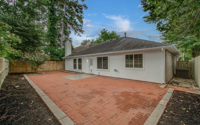 22718 Red Pine Dr, Tomball, TX 77375 - rear view of property with a fenced backyard, stucco siding, a shingled roof, a patio, and a chimney