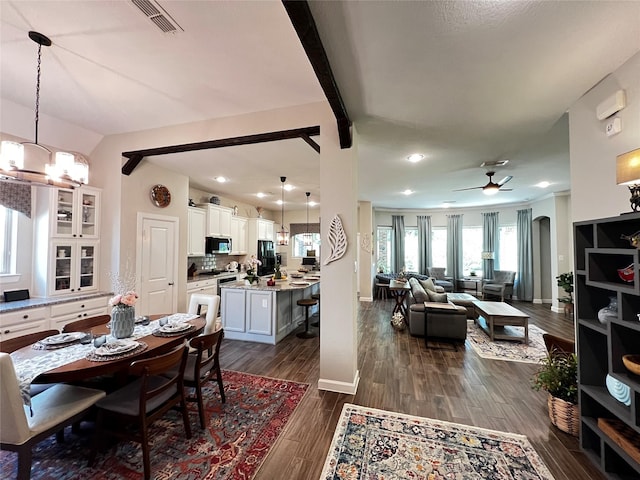 9327 Victory Canyon Ln, Tomball, TX 77375 - dining area featuring dark wood finished floors, a ceiling fan, and a chandelier