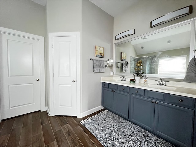 9327 Victory Canyon Ln, Tomball, TX 77375 - full bath with double vanity, a stall shower, wood finished floors, and vaulted ceiling