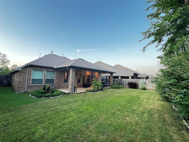 9327 Victory Canyon Ln, Tomball, TX 77375 - back of property with a patio area, brick siding, and a shingled roof