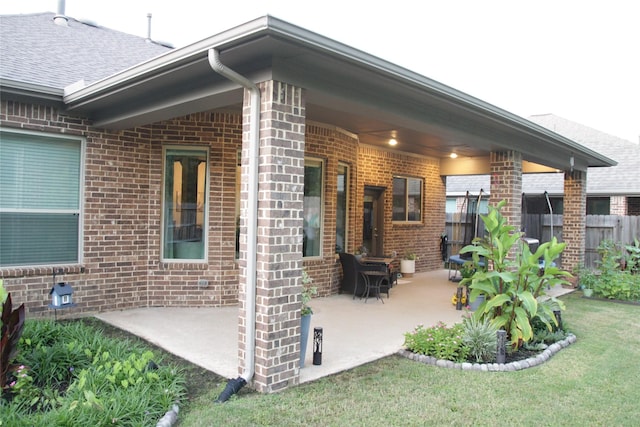 9327 Victory Canyon Ln, Tomball, TX 77375 - back of property featuring brick siding, a patio, and roof with shingles