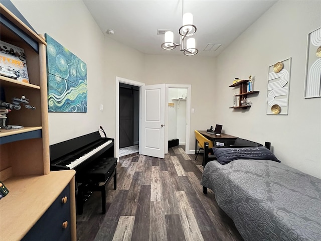 9327 Victory Canyon Ln, Tomball, TX 77375 - bedroom featuring dark wood-type flooring, an office area, and a chandelier