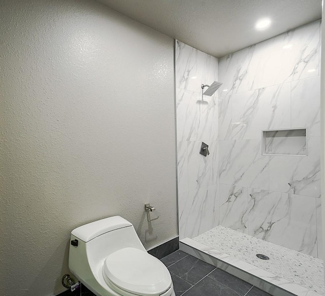 1302 W Adoue St, Alvin, TX 77511 - full bathroom with a marble finish shower, a textured wall, and a textured ceiling