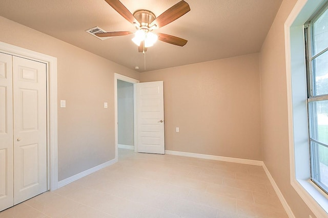 1302 W Adoue St, Alvin, TX 77511 - unfurnished bedroom featuring baseboards and a ceiling fan