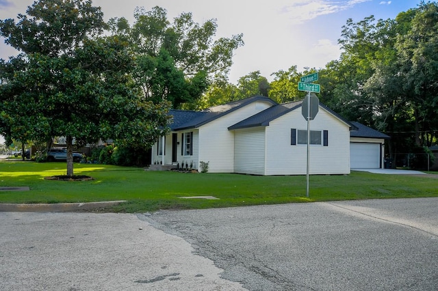1302 W Adoue St, Alvin, TX 77511 - view of front of home featuring a garage, a front lawn, and driveway