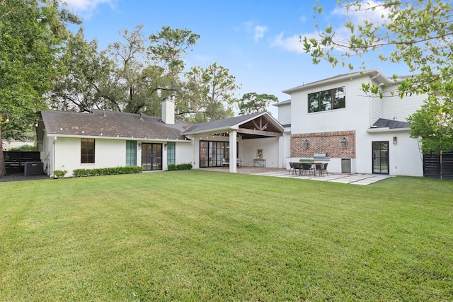 7202 Hartland Ave, Houston, TX 77055 - back of property featuring a chimney, french doors, a patio area, and stucco siding