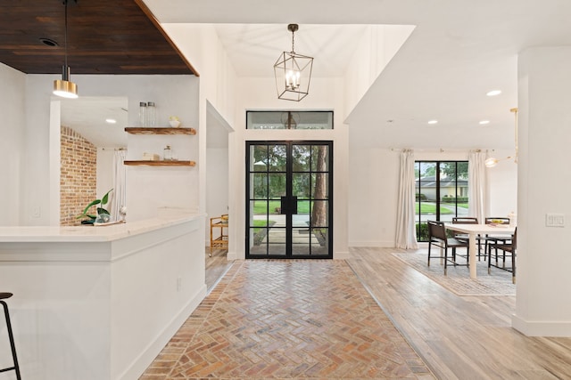 7202 Hartland Ave, Houston, TX 77055 - entryway featuring a chandelier, french doors, brick flooring, and recessed lighting