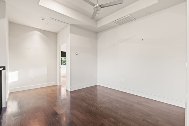 7202 Hartland Ave, Houston, TX 77055 - empty room with attic access, dark wood-style flooring, ceiling fan, a tray ceiling, and a smoke detector