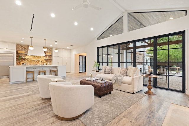 7202 Hartland Ave, Houston, TX 77055 - living room with high vaulted ceiling, light wood-style floors, a ceiling fan, and recessed lighting