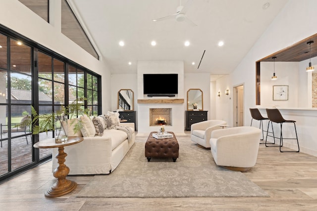 7202 Hartland Ave, Houston, TX 77055 - living room with high vaulted ceiling, wood finished floors, ceiling fan, a warm lit fireplace, and recessed lighting