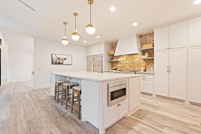 7202 Hartland Ave, Houston, TX 77055 - kitchen with custom range hood, open shelves, tasteful backsplash, an island with sink, and white cabinets