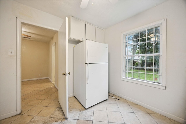 4526 Kingsbury St, Houston, TX 77021 - kitchen with freestanding refrigerator, healthy amount of natural light, white cabinets, and ceiling fan