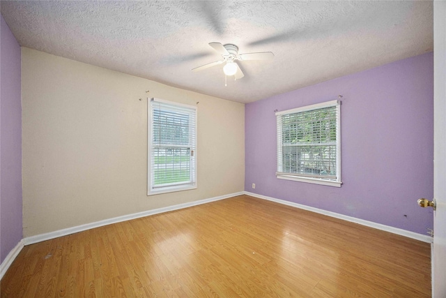 4526 Kingsbury St, Houston, TX 77021 - spare room with wood finished floors, ceiling fan, and a textured ceiling