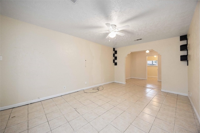 4526 Kingsbury St, Houston, TX 77021 - spare room with arched walkways, a ceiling fan, light tile patterned floors, and a textured ceiling