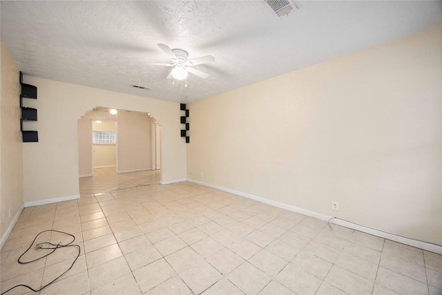 4526 Kingsbury St, Houston, TX 77021 - unfurnished room featuring arched walkways, ceiling fan, a textured ceiling, and light tile patterned floors