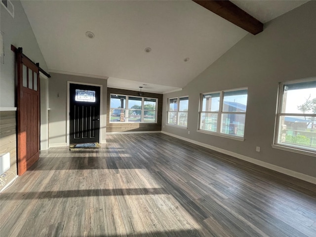 126 2nd Ave, Onalaska, TX 77360 - unfurnished living room with dark wood-type flooring, a barn door, beamed ceiling, high vaulted ceiling, and plenty of natural light