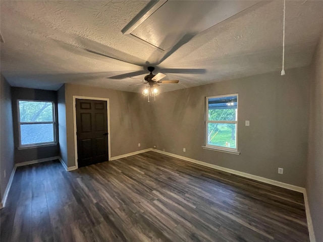 126 2nd Ave, Onalaska, TX 77360 - unfurnished room featuring dark wood finished floors, a textured ceiling, and a ceiling fan
