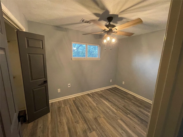 126 2nd Ave, Onalaska, TX 77360 - unfurnished room featuring ceiling fan, a textured ceiling, and dark wood finished floors