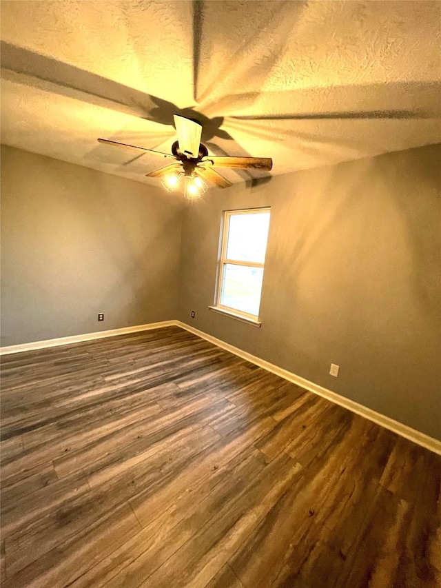 126 2nd Ave, Onalaska, TX 77360 - unfurnished room featuring a ceiling fan, dark wood-style flooring, and a textured ceiling