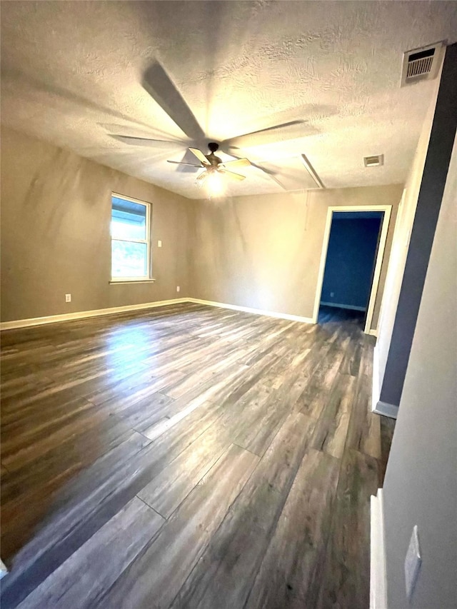 126 2nd Ave, Onalaska, TX 77360 - empty room with a textured ceiling, dark wood-style flooring, and a ceiling fan