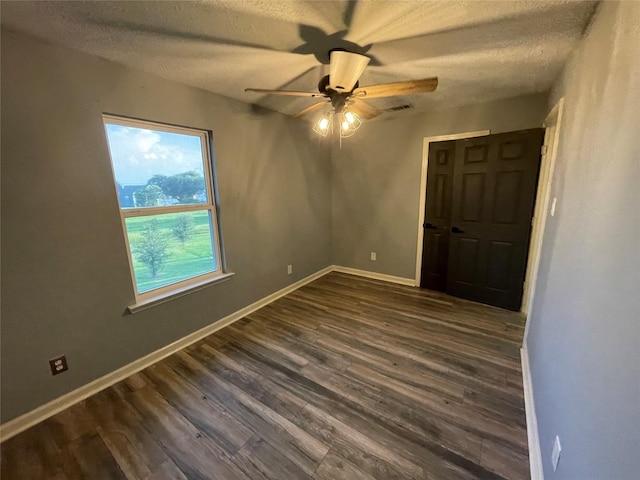 126 2nd Ave, Onalaska, TX 77360 - spare room featuring a ceiling fan, dark wood-style floors, and a textured ceiling