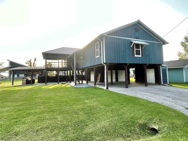 126 2nd Ave, Onalaska, TX 77360 - rear view of house with a yard, stairs, and driveway