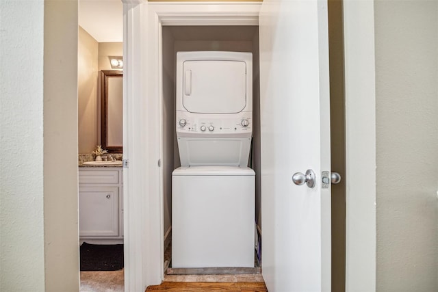 11315 S Main St Unit 1205, Houston, TX 77025 - laundry room with stacked washer / drying machine and light wood-style flooring