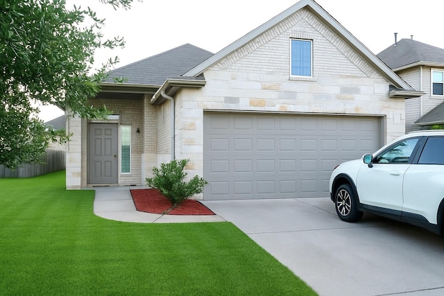 3543 Paganini Pl, Katy, TX 77493 - view of front facade featuring driveway, an attached garage, a front yard, and stone siding