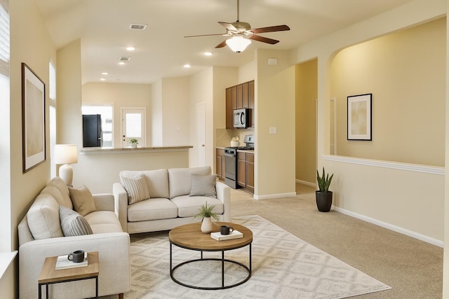 3543 Paganini Pl, Katy, TX 77493 - living area featuring light colored carpet, a ceiling fan, arched walkways, and recessed lighting