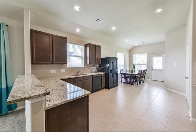 3543 Paganini Pl, Katy, TX 77493 - kitchen with black appliances, dark brown cabinets, recessed lighting, light stone countertops, and a peninsula