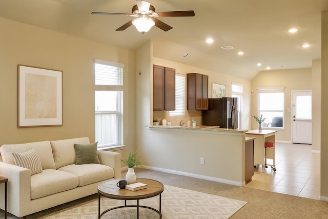 3543 Paganini Pl, Katy, TX 77493 - living room featuring lofted ceiling, ceiling fan, plenty of natural light, recessed lighting, and light carpet