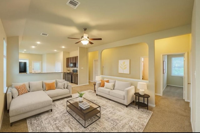 3543 Paganini Pl, Katy, TX 77493 - living room featuring light colored carpet, arched walkways, a ceiling fan, and recessed lighting