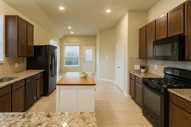 3543 Paganini Pl, Katy, TX 77493 - kitchen featuring black appliances, tasteful backsplash, recessed lighting, and light stone counters
