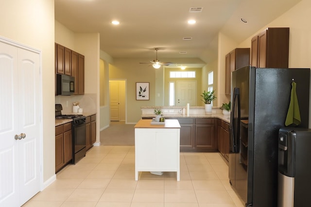 3543 Paganini Pl, Katy, TX 77493 - kitchen featuring black appliances, a peninsula, ceiling fan, recessed lighting, and a center island