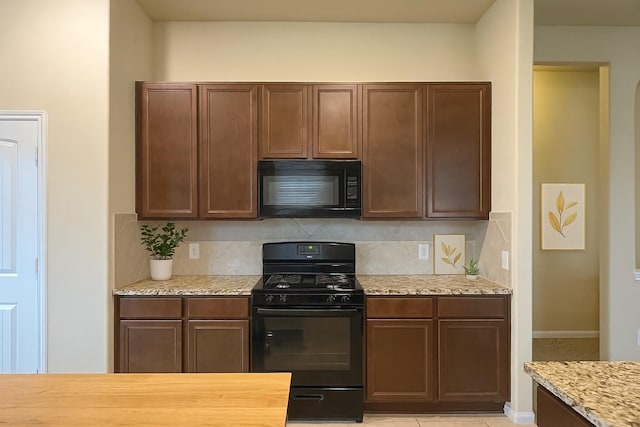 3543 Paganini Pl, Katy, TX 77493 - kitchen featuring black appliances, decorative backsplash, and light stone countertops