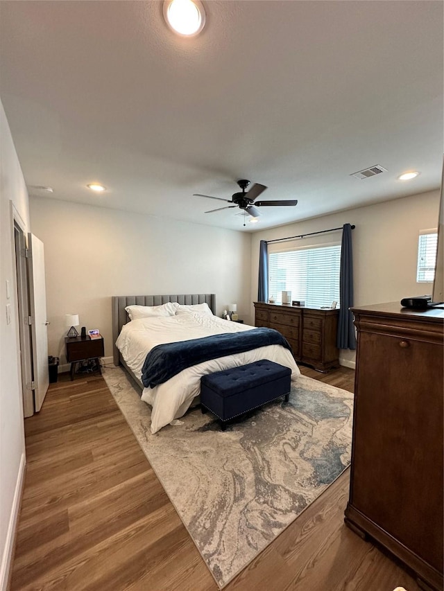 311 Eado Park Cir, Houston, TX 77020 - bedroom with multiple windows, wood finished floors, a ceiling fan, and recessed lighting