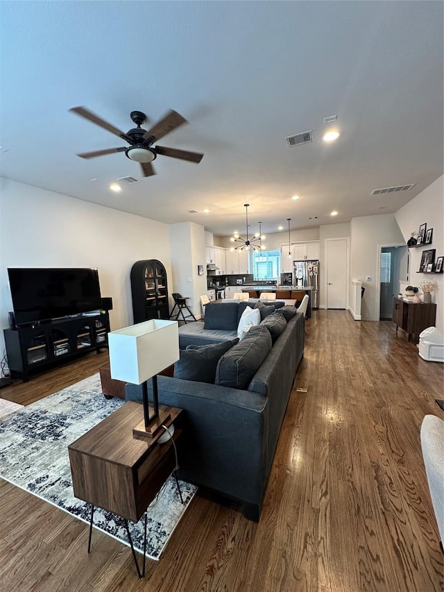 311 Eado Park Cir, Houston, TX 77020 - living room featuring dark wood finished floors, ceiling fan, recessed lighting, and a chandelier