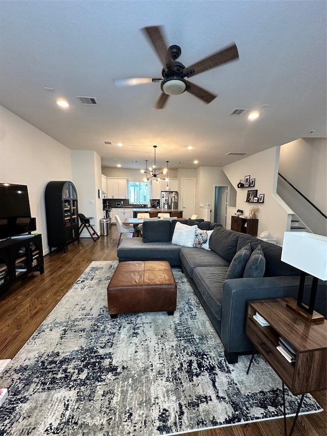 311 Eado Park Cir, Houston, TX 77020 - living area featuring ceiling fan, stairway, dark wood-style floors, a chandelier, and recessed lighting