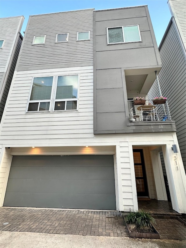 311 Eado Park Cir, Houston, TX 77020 - modern home featuring a balcony, a garage, and driveway