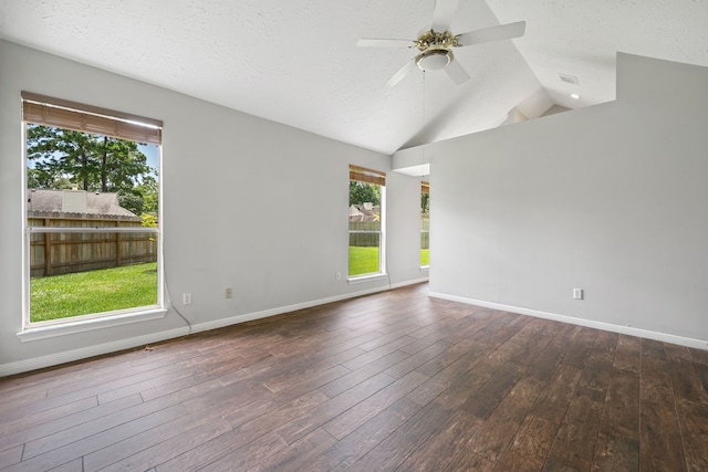 3518 Grove Oaks Dr, Houston, TX 77339 - unfurnished room featuring healthy amount of natural light, dark wood-style flooring, a ceiling fan, lofted ceiling, and a textured ceiling