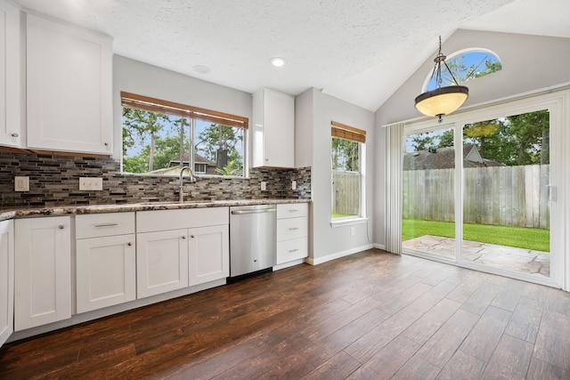 3518 Grove Oaks Dr, Houston, TX 77339 - kitchen with stainless steel dishwasher, stone countertops, vaulted ceiling, decorative backsplash, and white cabinets