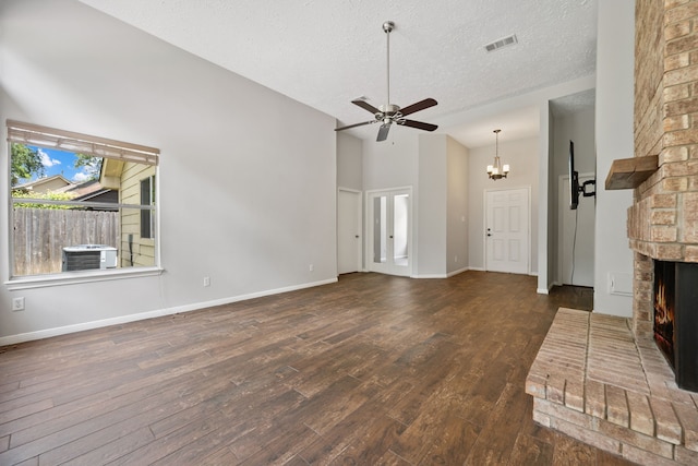 3518 Grove Oaks Dr, Houston, TX 77339 - unfurnished living room featuring a fireplace, wood finished floors, a textured ceiling, a ceiling fan, and a chandelier