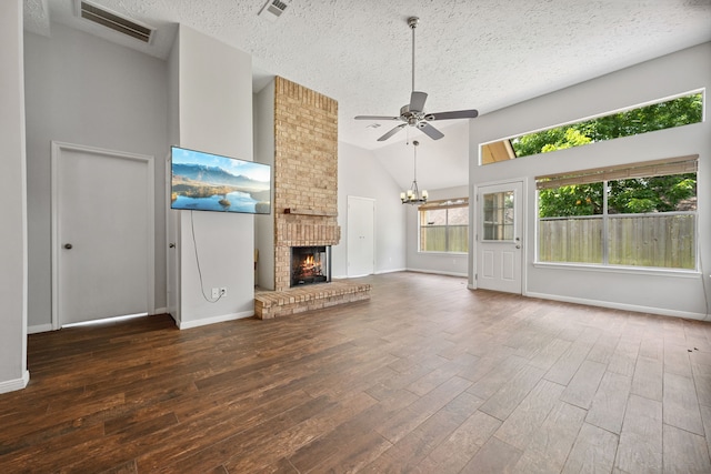 3518 Grove Oaks Dr, Houston, TX 77339 - unfurnished living room with a textured ceiling, a ceiling fan, wood finished floors, a chandelier, and high vaulted ceiling