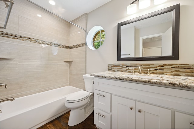 3518 Grove Oaks Dr, Houston, TX 77339 - full bath with vanity, wood finished floors, washtub / shower combination, and backsplash