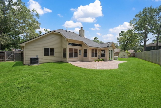 3518 Grove Oaks Dr, Houston, TX 77339 - rear view of property featuring a chimney, a fenced backyard, a patio area, a shed, and roof with shingles