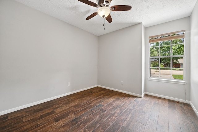 3518 Grove Oaks Dr, Houston, TX 77339 - spare room with dark wood-style flooring, a ceiling fan, and a textured ceiling