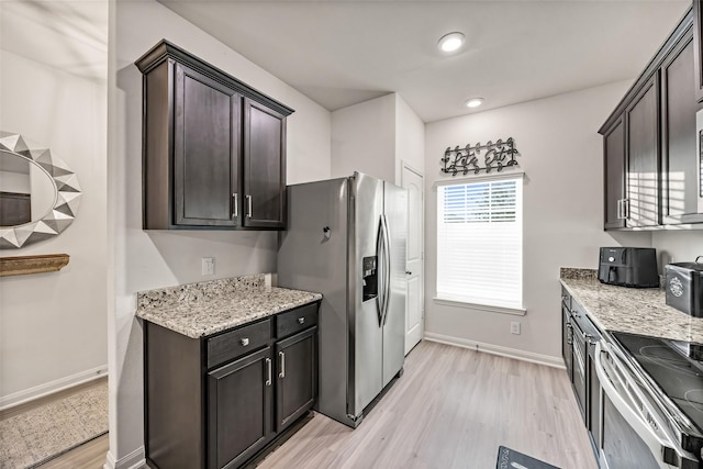 11034 Hillside Creek Dr, Humble, TX 77396 - kitchen with stainless steel appliances, light wood-type flooring, light stone counters, dark brown cabinetry, and recessed lighting