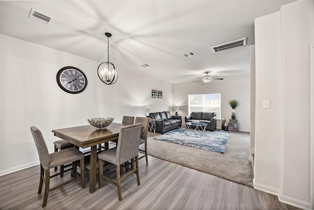 11034 Hillside Creek Dr, Humble, TX 77396 - dining space featuring wood finished floors, ceiling fan, and a chandelier