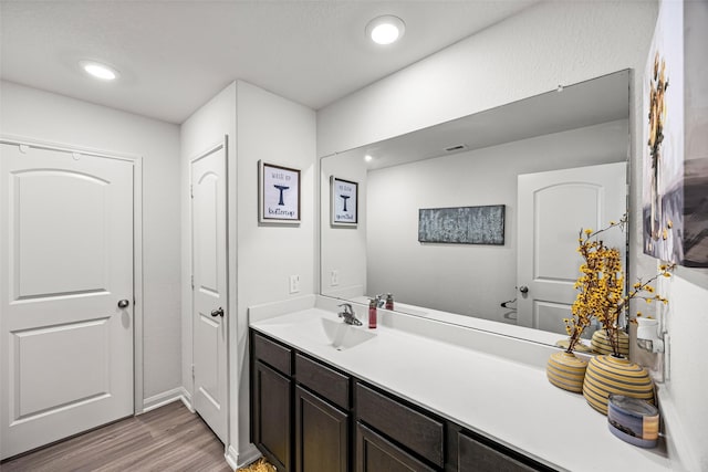 11034 Hillside Creek Dr, Humble, TX 77396 - bathroom with wood finished floors, vanity, and recessed lighting
